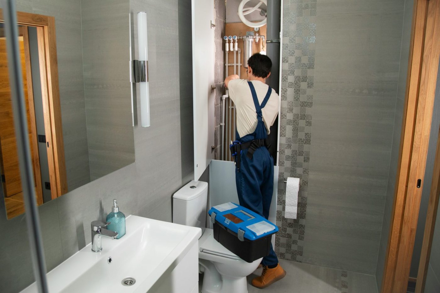 Plumber at work in a bathroom